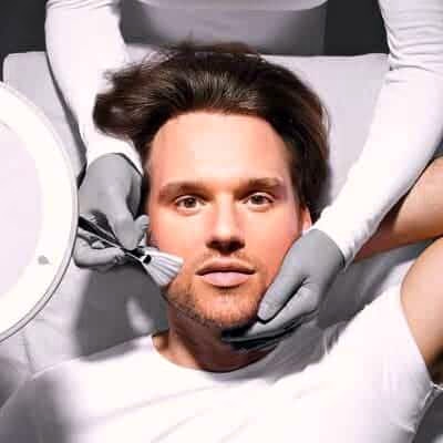 Mann beim Gesichtspeeling